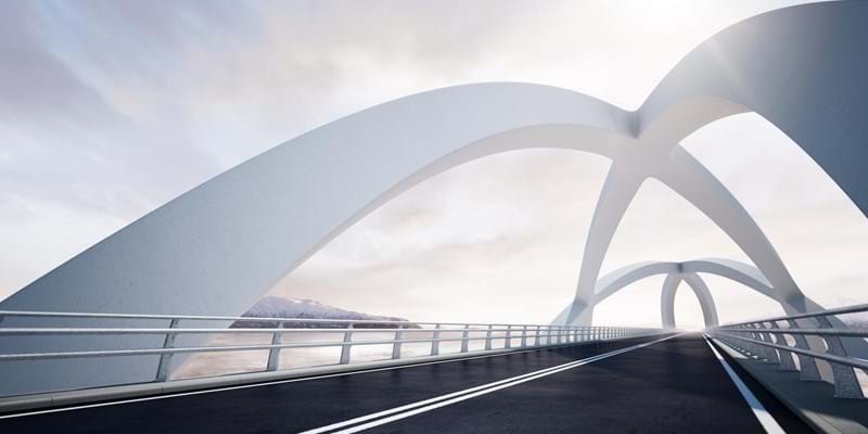 Modern curved architectural white bridge, against a backdrop of a river and mountain landscape on the left.