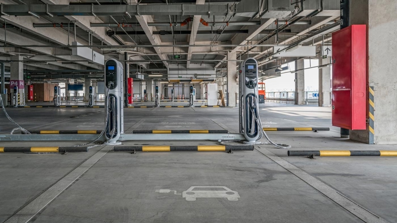 An empty car parking complex, with electrical vehicle charging stations at each bay.
