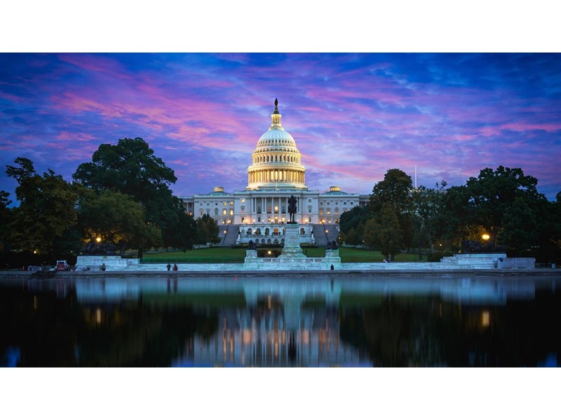 Capitol Hill Building and reflection in the Capitol Lake, at dusk. Washington DC, USA.