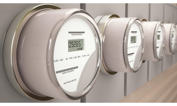 A row of digital watts per hour meters on a wall.