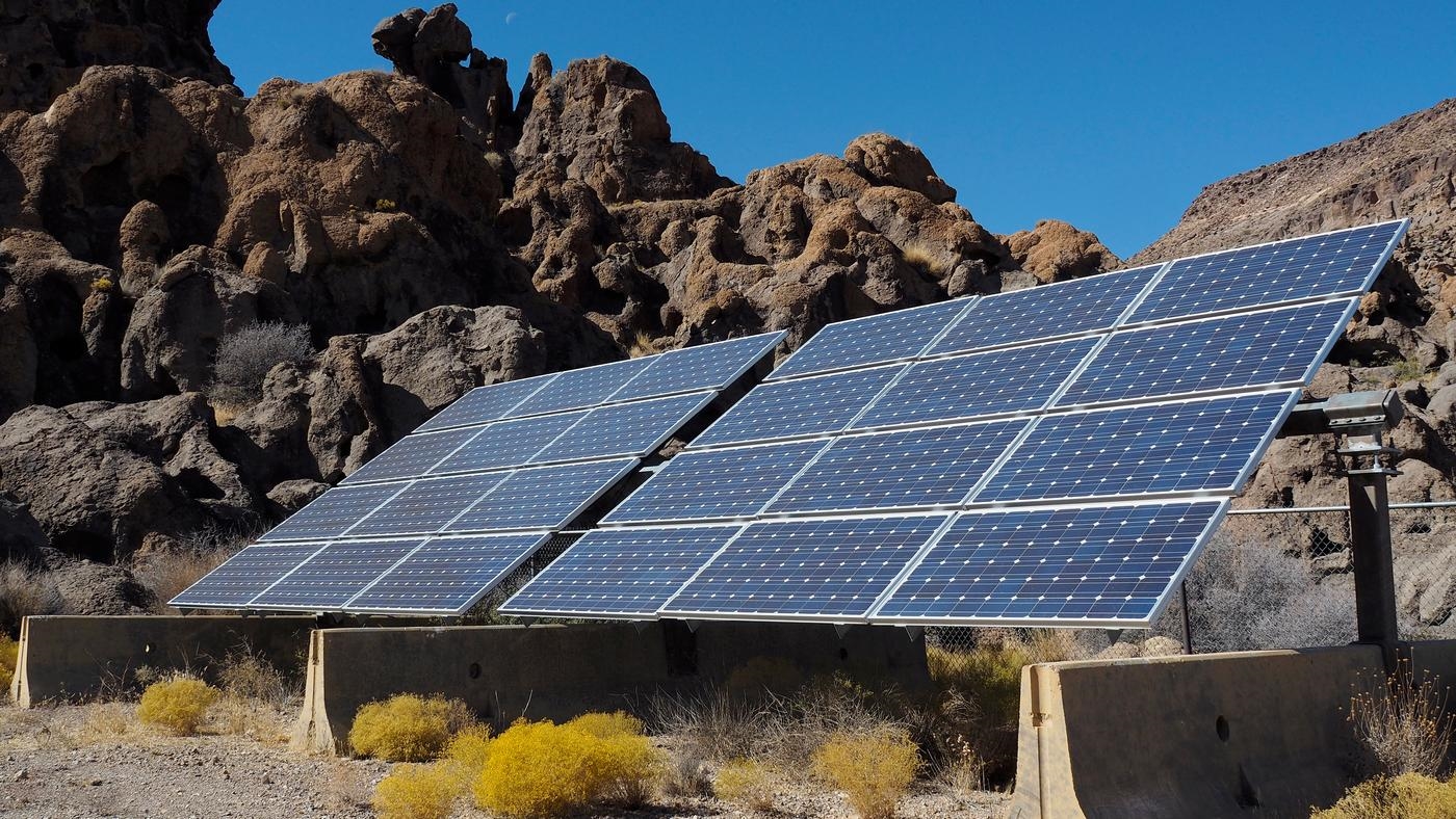Solar panels at the edge of a rocky cliff.
