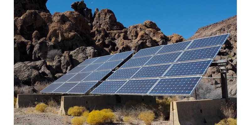 Solar panels at the edge of a rocky cliff.
