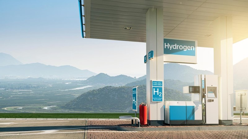 A covered hydrogen fuel cell vehicle charging station in the mountainous countryside.