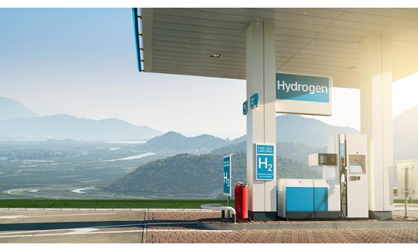 A covered hydrogen fuel cell vehicle charging station in the mountainous countryside.