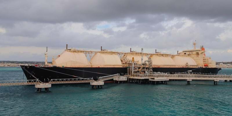 A Liquified Natural Gas Floating Storage Unit delivers LNG to the onshore regasification plant feeding natural gas to the power plant.