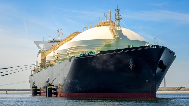 Low angle view of a large natural gas carrier ship in a harbour on a clear summer day. Port of Rotterdam, the Netherlands.