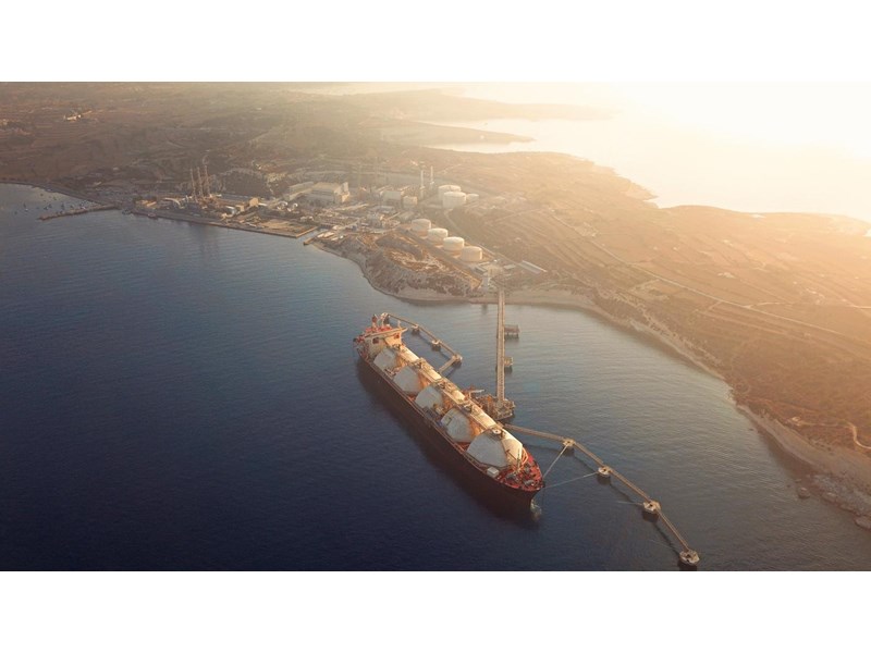 High angle view of a Gas Tanker moored to the jetty close to a power station during a foggy sunrise.