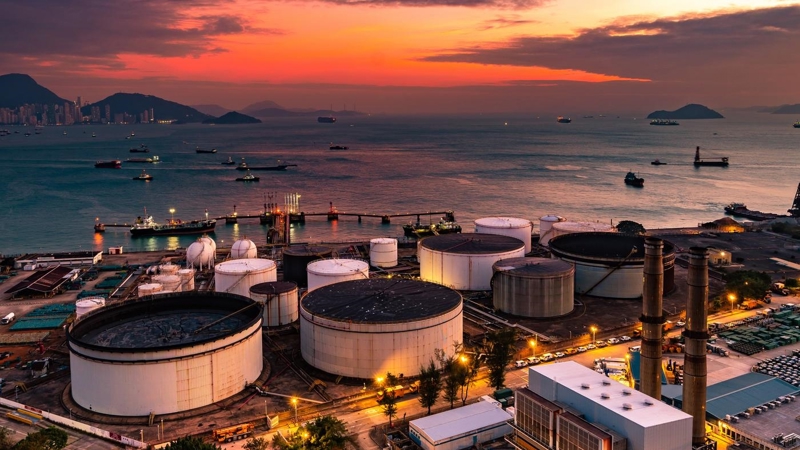 The tank is in the light of the industrial area. With the sky of the sunset.