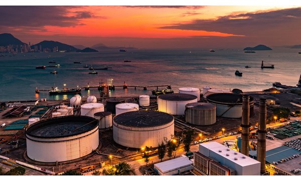 The tank is in the light of the industrial area. With the sky of the sunset.