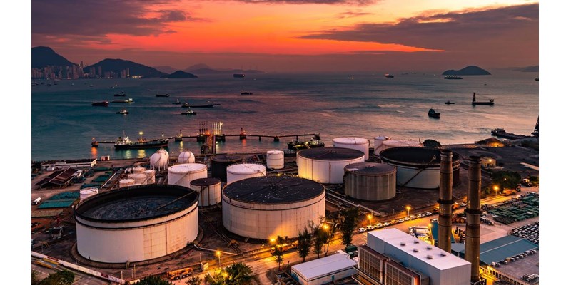 The tank is in the light of the industrial area. With the sky of the sunset.