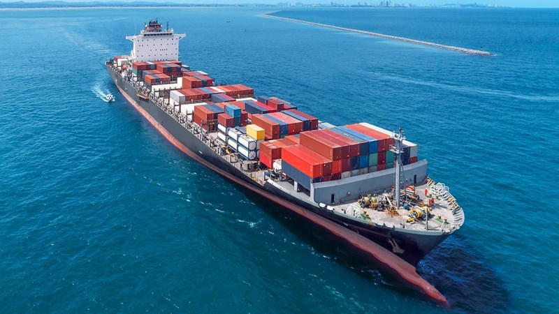 Aerial view of cargo ship running on sea close warehouse harbour at Thailand .