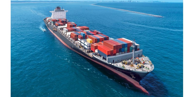 Aerial view of cargo ship running on sea close warehouse harbour at Thailand .