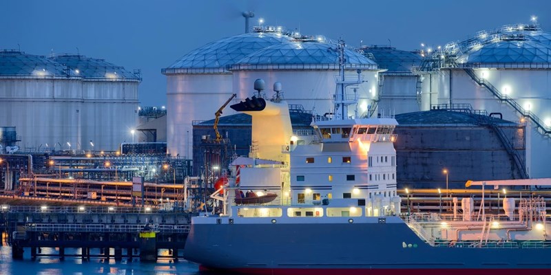 Liquid Natural Gas storage tanks and tanker at dusk, Port of Rotterdam.