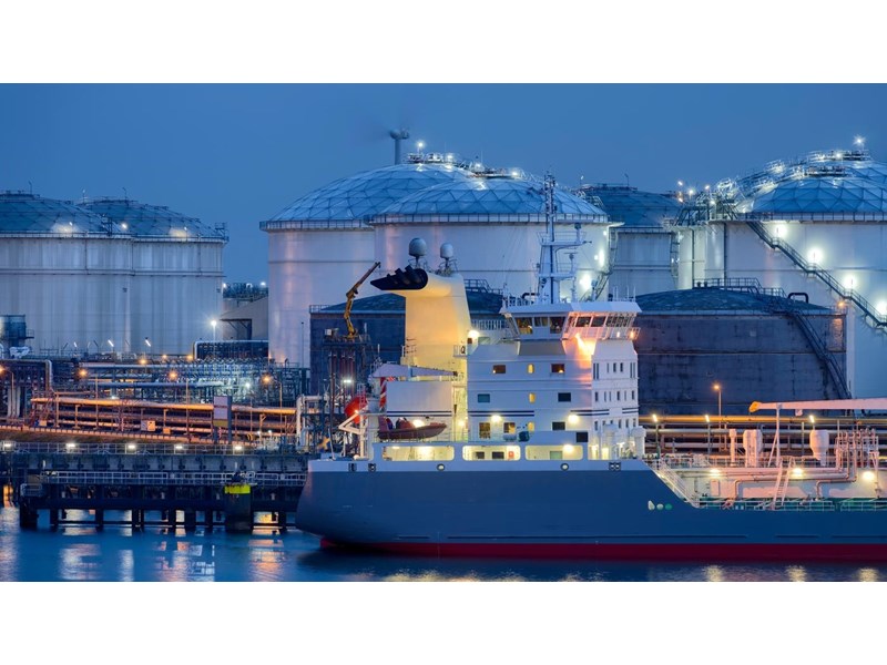 Liquid Natural Gas storage tanks and tanker at dusk, Port of Rotterdam.