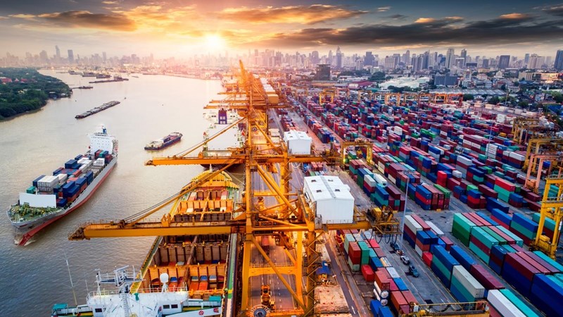 Logistics and transportation of Container Cargo ship and Cargo plane with working crane bridge in shipyard at sunrise, logistic import export and transport industry background.