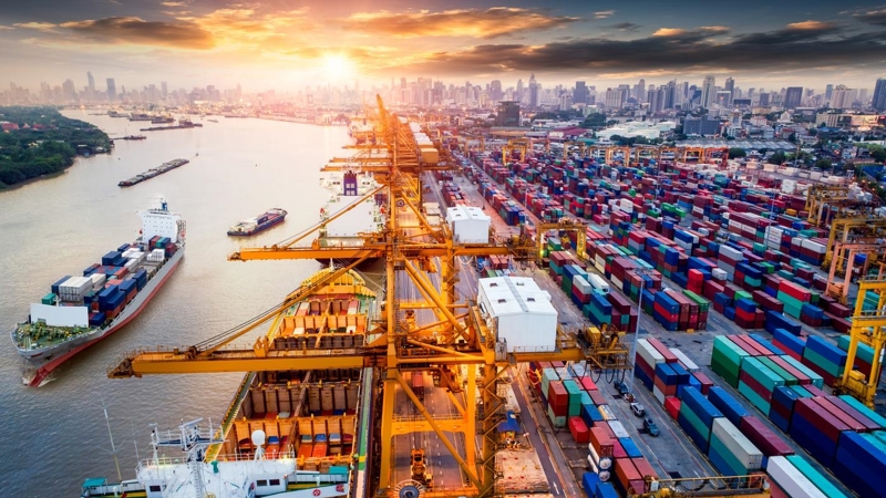 Logistics and transportation of Container Cargo ship and Cargo plane with working crane bridge in shipyard at sunrise, logistic import export and transport industry background.