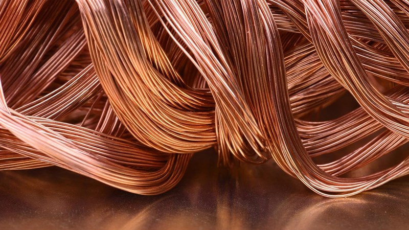 A pile of copper wire on a metal surface.