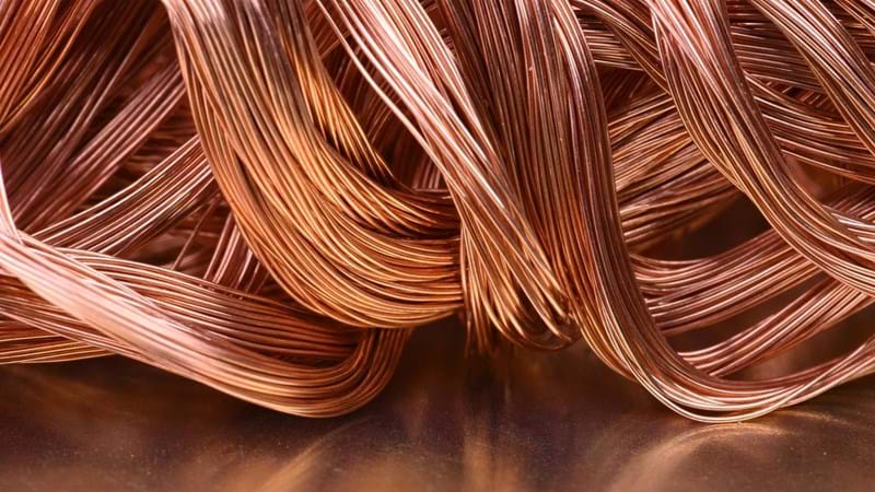 A pile of copper wire on a metal surface.