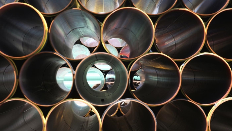 Stacked rows of metallic tubes.