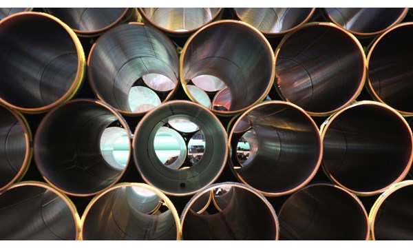 Stacked rows of metallic tubes.