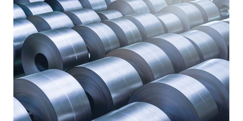 Rolled steel coils in a factory.