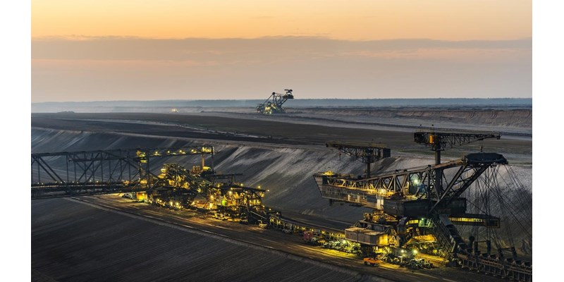 An open pit mine at dusk.