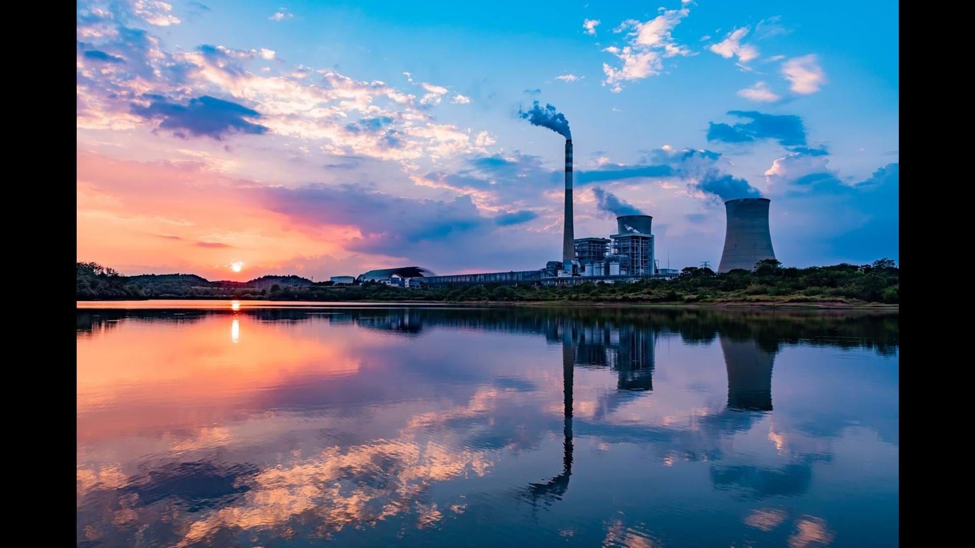 Nuclear power plant after sunset. Dusk landscape with big chimneys.