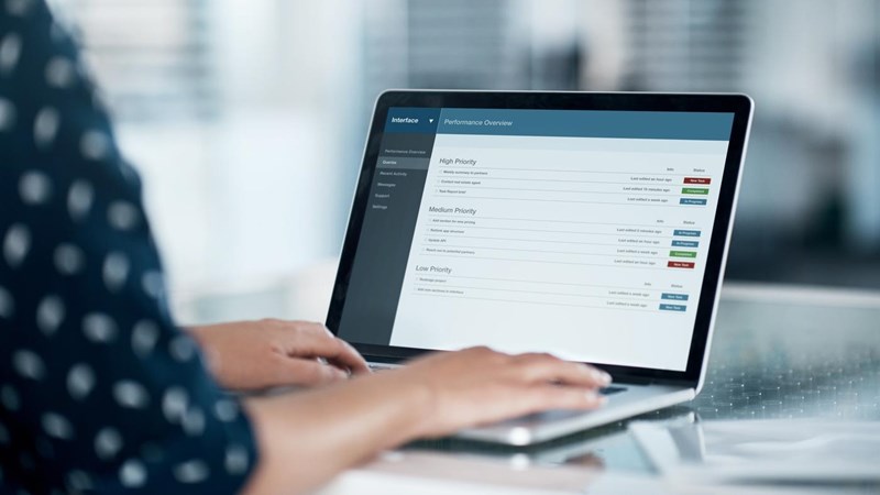 Cropped shot of a businesswoman using a laptop at her desk in a modern office