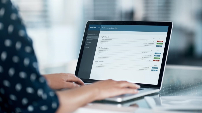 Cropped shot of a businesswoman using a laptop at her desk in a modern office