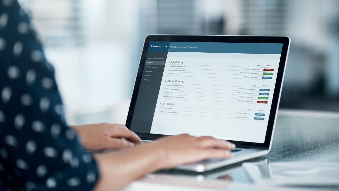 Cropped shot of a businesswoman using a laptop at her desk in a modern office
