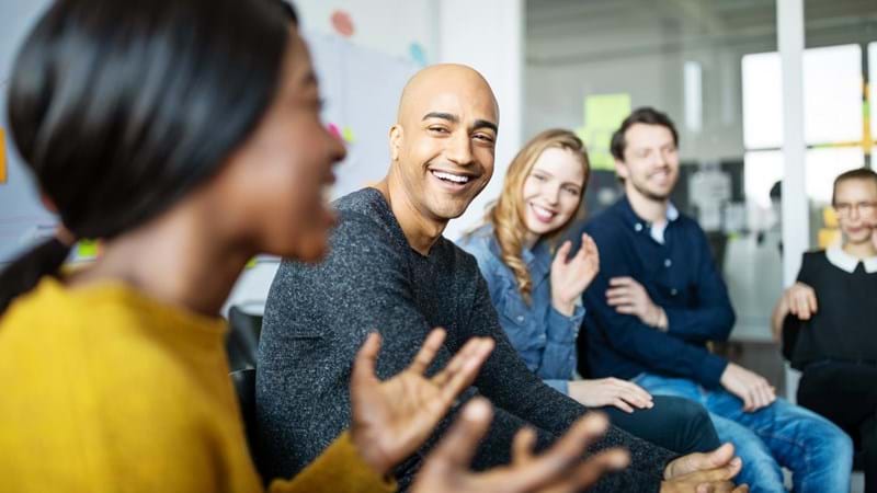 Group of diverse business people talking in a meeting. Business team smiling during a meeting.
