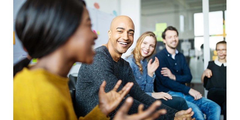 Group of diverse business people talking in a meeting. Business team smiling during a meeting.