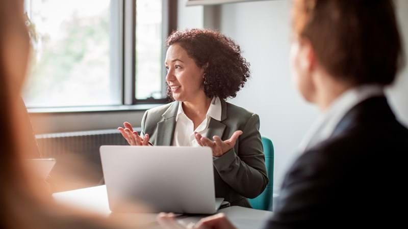 Close up of a group of business people having a meeting in a conference room.