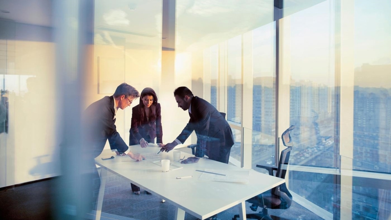 Adult senior diverse multi-ethnic Caucasian Hispanic Middle Eastern CEO executive team business people together in conference meeting room in contemporary modern office bright sunny daylight sunset dusk talking discussing planning organizing strategy well dressed suit and tie teamwork cooperation diversity multi-ethnic problems solutions unity cityscape downtown urban new beginnings breaking new ground dreamlike decisions choices the way forward diversity