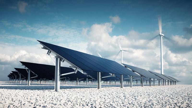 Solar panels and wind turbines in the desert.
