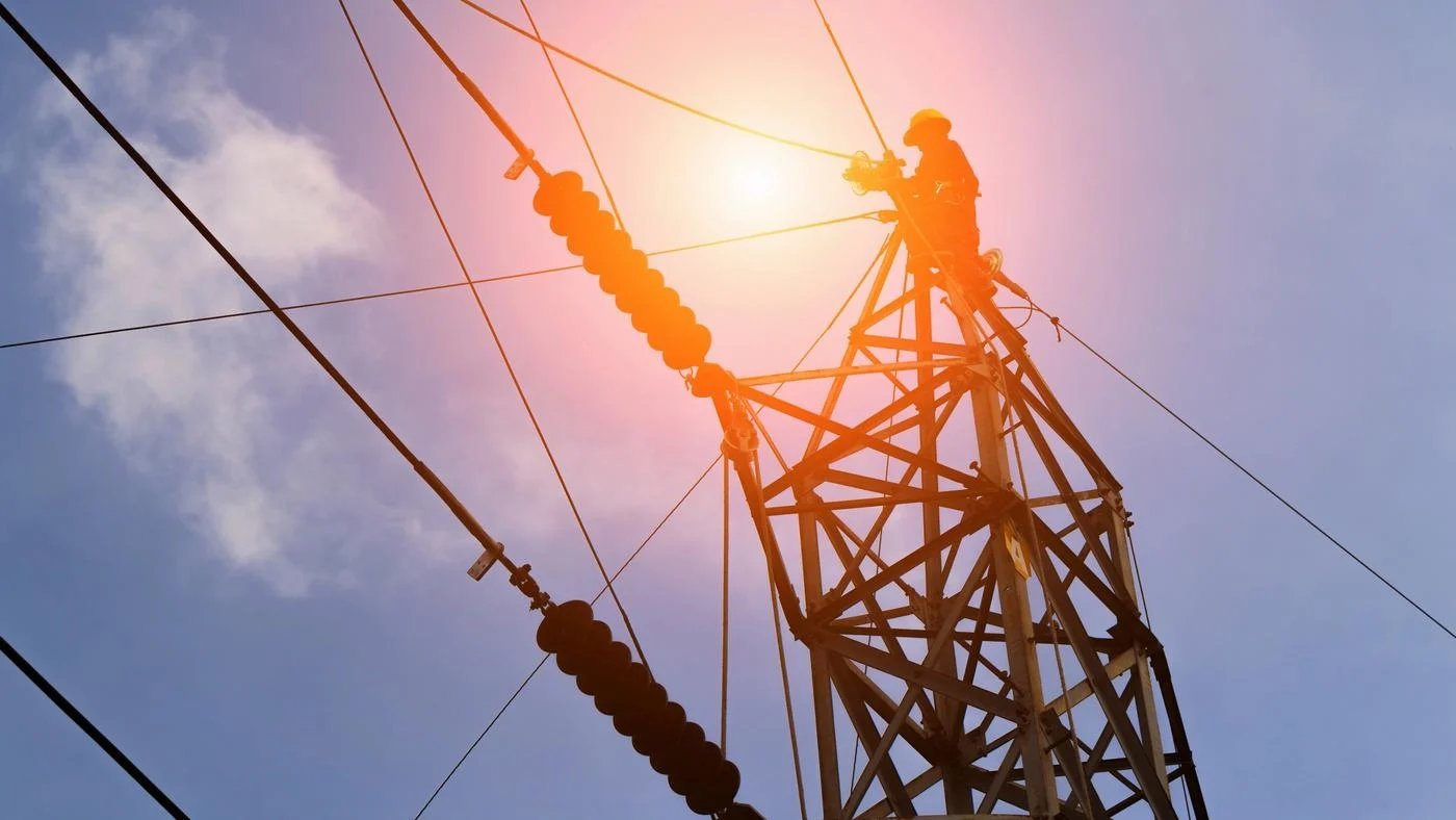 A man is working on a high voltage power line.