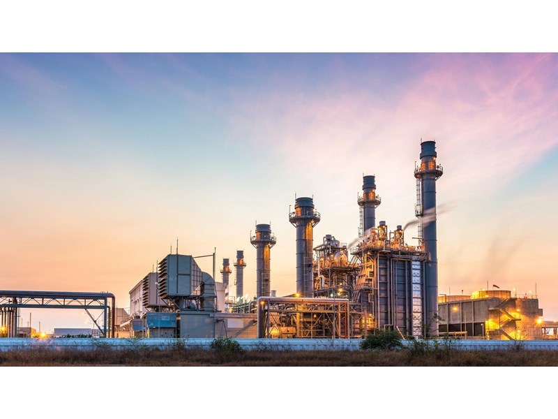 A large industrial plant at sunset.