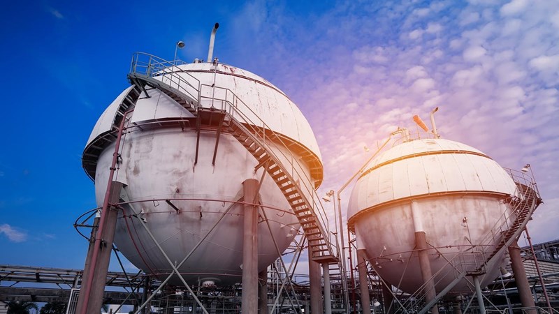 Gas storage sphere tanks in oil and gas refinery industrial plant on blue sky with white cloud background.