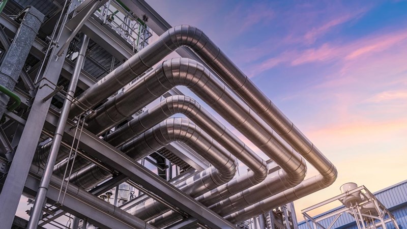 The pipe of factory, close-up of industrial steel pipelines at oil-refinery plant and sky.