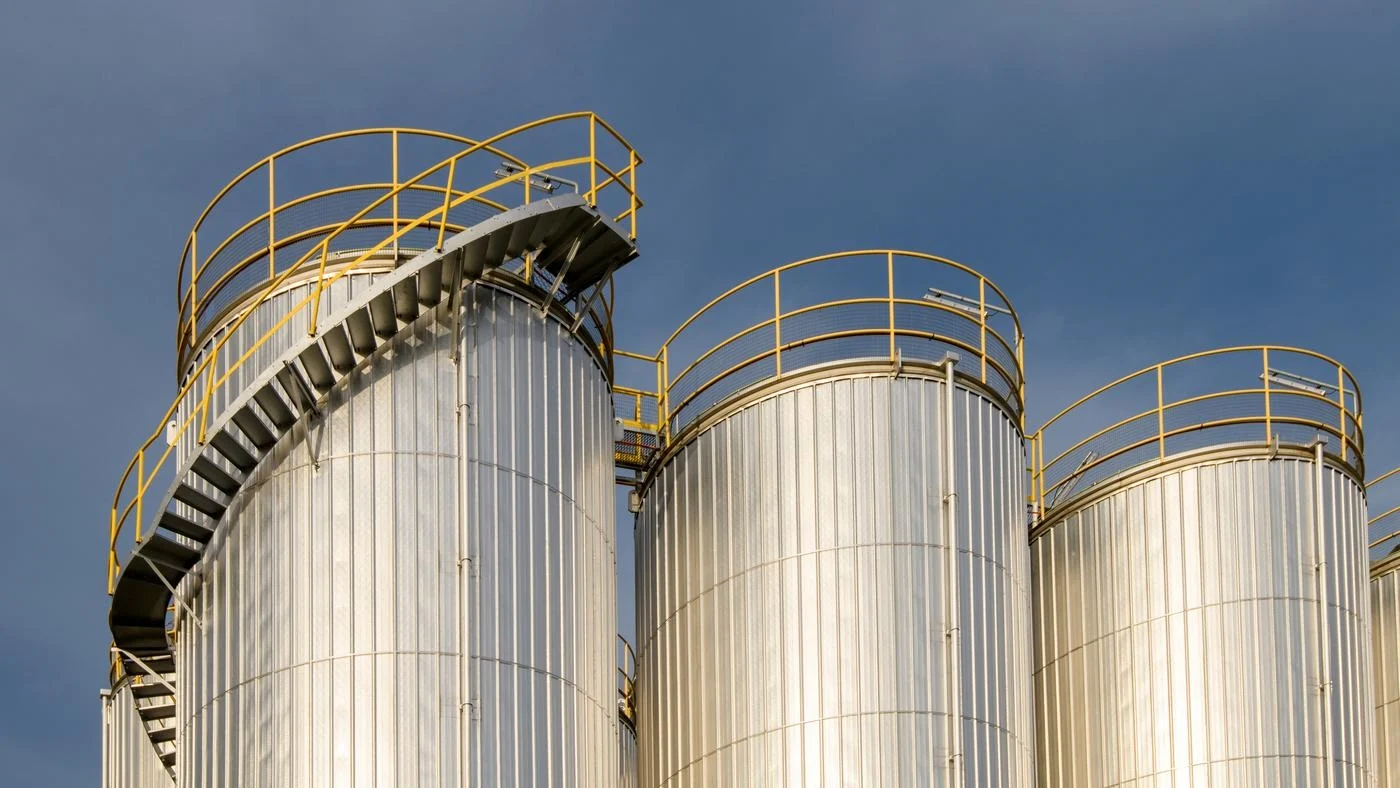 A group of metal silos in a factory.