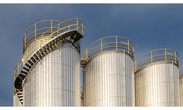 A group of metal silos in a factory.
