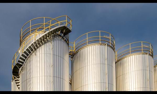 A group of metal silos in a factory.