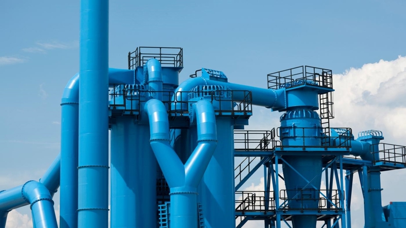 Blue industrial pipes of the exterior of a factory.