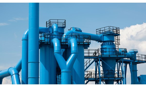 Blue industrial pipes of the exterior of a factory.