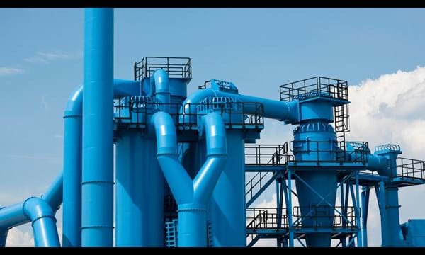 Blue industrial pipes of the exterior of a factory.