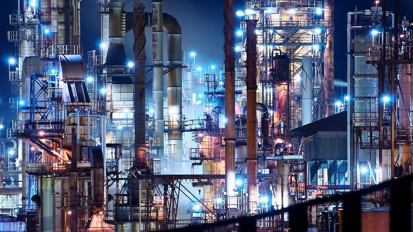 Vast illuminated refinery at night.
