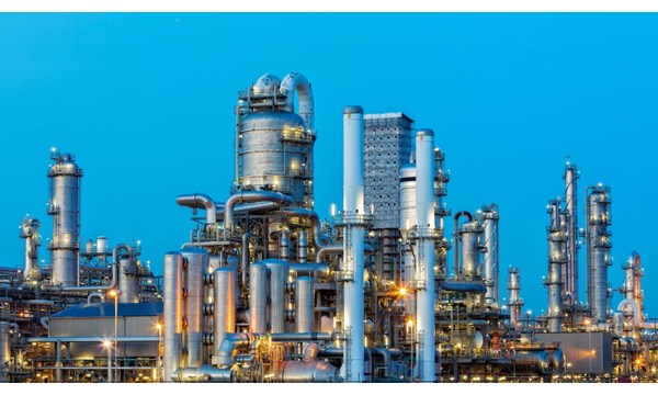 A large, modern petrochemical plant at dusk in industrial district near Rotterdam, Netherlands, Benelux, Europe. Distillation towers and other installations are visible against blue sky. 50 megapixel image taken with Canon EOS 5Ds, digital blending technique, long exposure with tripod.
