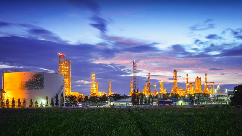 Petrochemical plant (Oil refinery) plant is illuminated at dusk.