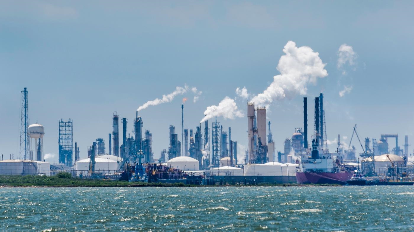 Atmospheric distortion blurs the view of the petrochemical oil processing refinery plant of the industrial skyline in Texas City, Texas, USA, on Galveston Bay and the Gulf of Mexico