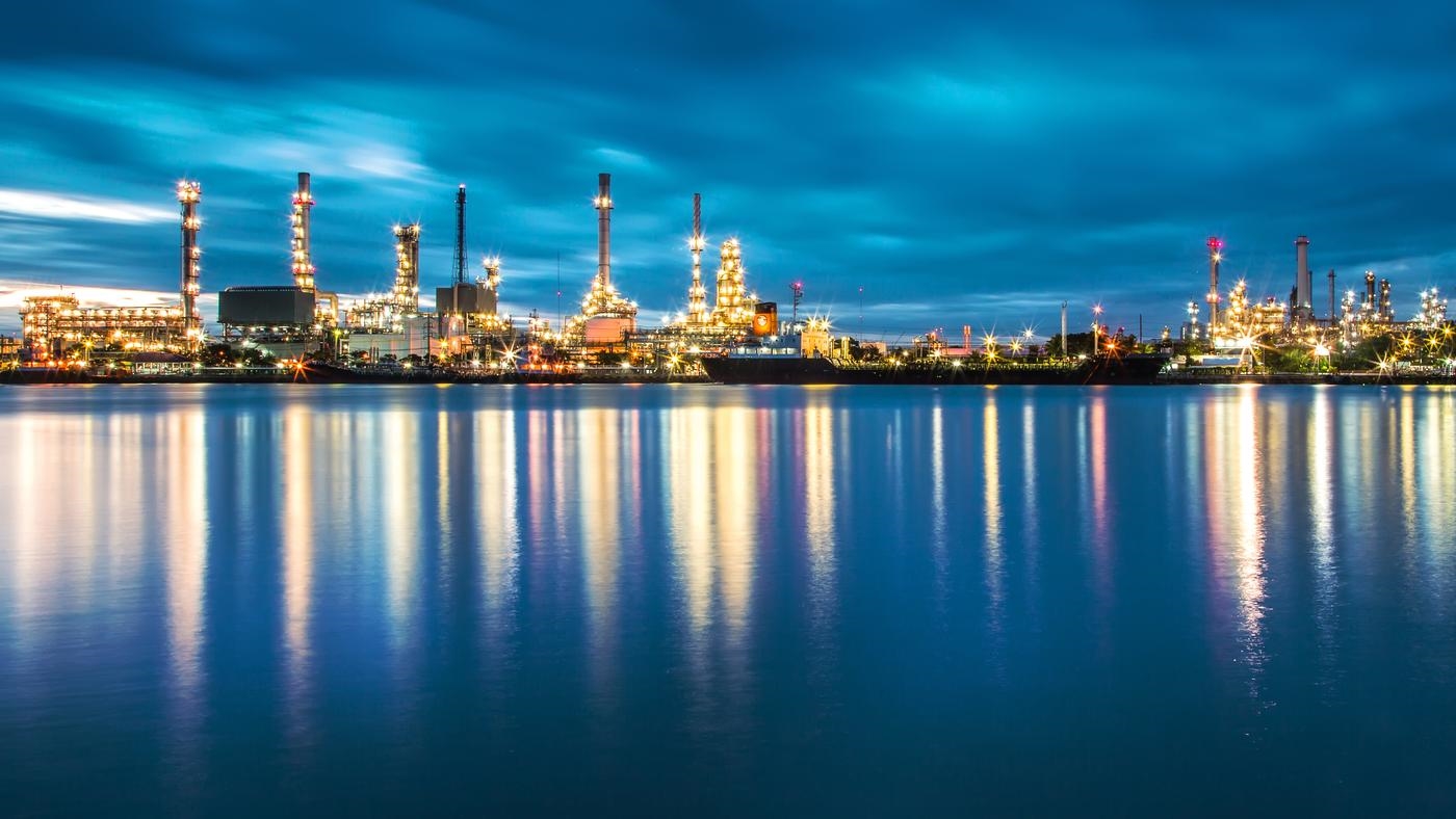 Panorama of Oil refinery with reflection from the river it sits next to.